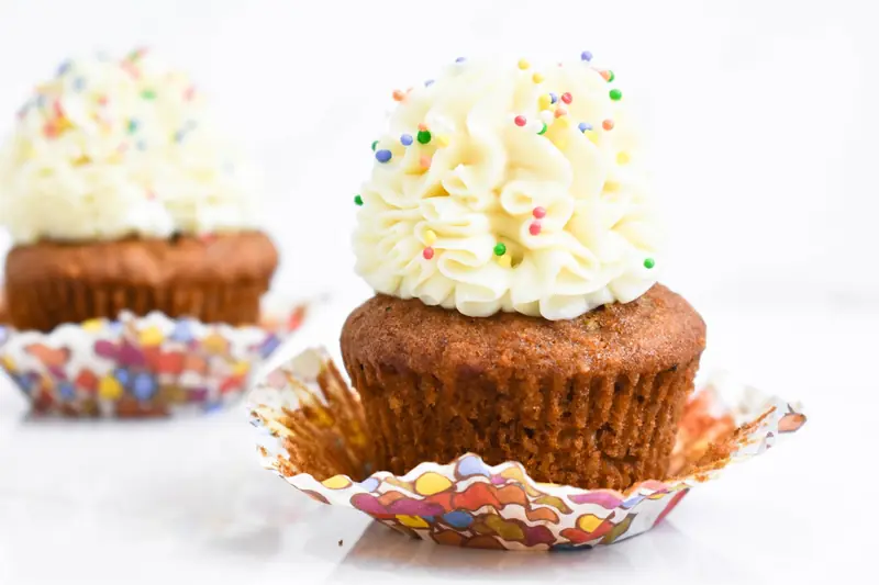 Close-up of cupcakes topped with buttercream frosting and colorful sprinkles, perfect for celebrations