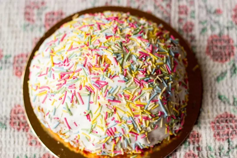 Festive dome-shaped cake with vibrant sprinkles, perfect for celebrations and parties