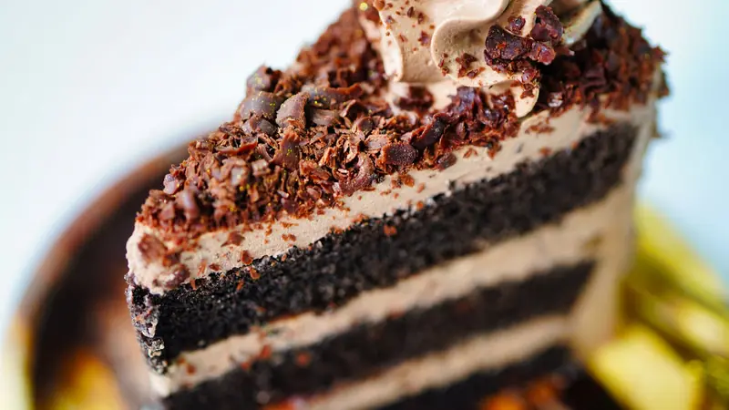 Close-up of a decadent chocolate layer cake with rich frosting, perfect for dessert lovers